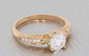 An Enchanting Rose Gold And Diamond Engagement Ring With Intricate Scrollwork To Give The Ring A Fairy Tale Feel