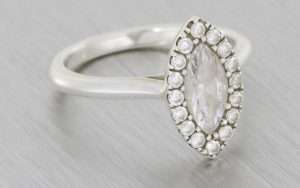 Platinum marquise halo proposal ring framed with a round brilliant diamond halo