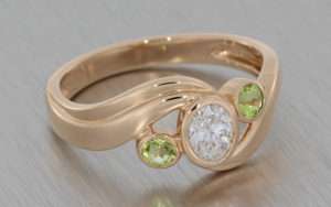 Rose Gold Oval Swirl Ring Set with Diamond and Accented with Peridot