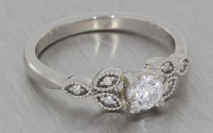 Platinum round diamond ring with diamond shoulder elements