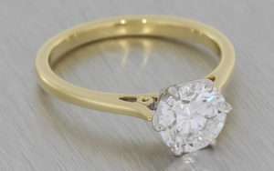 Traditional Solitaire diamond ring set in platinum on a yellow gold band