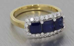 Mixed Metal Sapphire Trilogy Ring with a Cluster of Diamonds