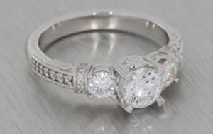 18K white three stone diamond ring with grain set shoulders