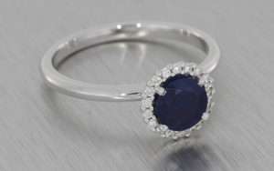 18k White Gold Ring Set with a Beautiful Sapphire Surrounded by a Cluster of Diamonds