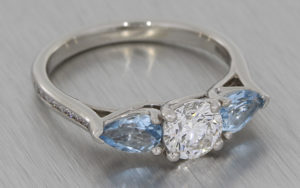 Palladium three stone, round diamond and pear shape aquamarine ring